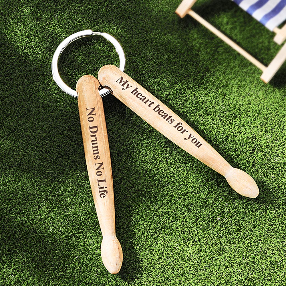 Close-up of personalised wooden drumstick keyring showing engraved photograph and custom text on solid wood charm with sturdy metal key ring — custom photo & text drummer gift
