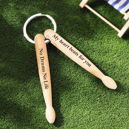 Close-up of personalised wooden drumstick keyring showing engraved photograph and custom text on solid wood charm with sturdy metal key ring — custom photo & text drummer gift
