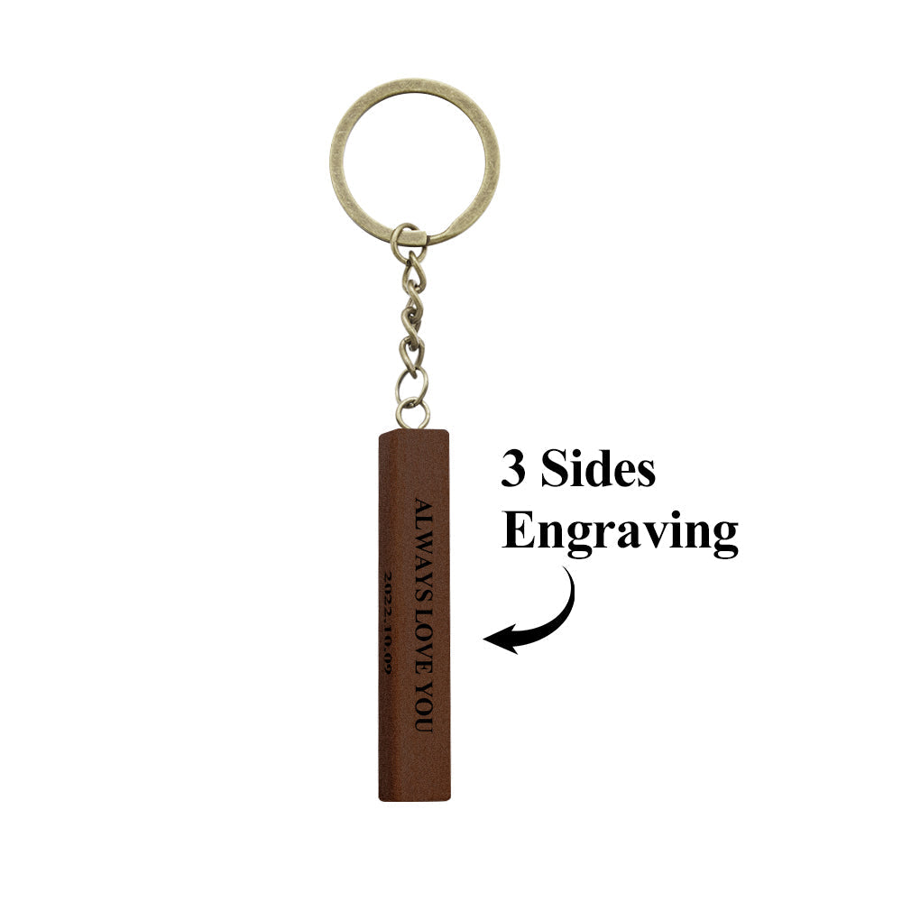 Close-up of personalised 3-sided wooden keyring showing detailed laser-engraved photo and inscription — custom anniversary gift for him or her