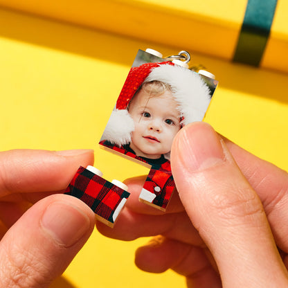 Personalised photo bricks displayed wall-mounted as a vertical photo keychain – custom puzzle keyring