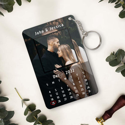 Close-up of personalised acrylic keyring showing calendar date and couple photo – bespoke custom photo keychain for Valentine's Day or birthday