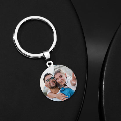 Close-up of custom name stainless steel keychain showing engraved message and clear photo reproduction on a personalised 'Drive Safe' photo keyring