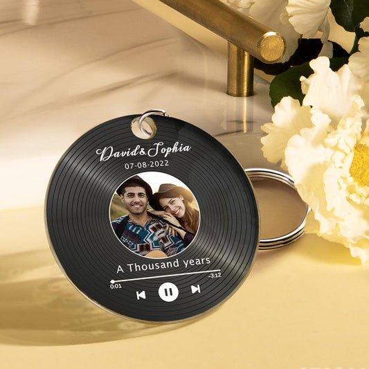 Lifestyle shot of personalised Spotify code keyring on a set of keys and gift packaging, showcasing the mini acrylic music disc keyring as a bespoke birthday or Christmas music gift