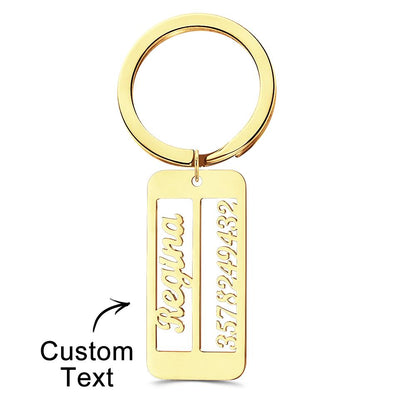 Close-up of a personalised emergency contact keyring showing engraved text on the metal surface.