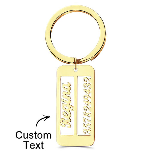 Close-up of a personalised emergency contact keyring showing engraved text on the metal surface.
