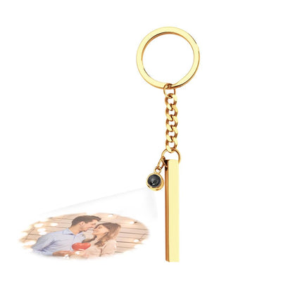 Personalised Photo Projection Keyring shown with smartphone camera demonstrating the micro-photo projection effect – unique engraved cube pendant gift