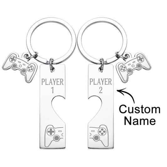 Pair of custom engraved game console keyrings on white background — personalised matching set for couples