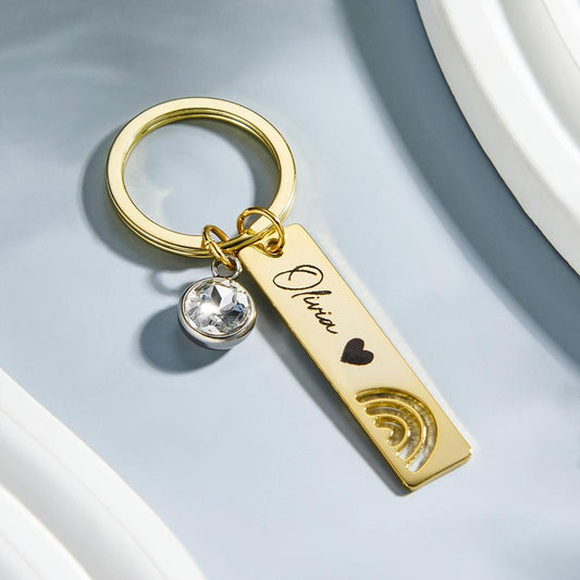 Handheld personalised engraved rainbow keyring attached to keys, showcasing the colourful design and custom text — perfect custom gift for birthdays, anniversaries or friends