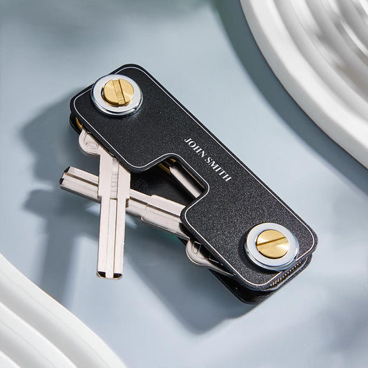 Close-up of a personalised engraved metal keyring with a sleek, minimalist design — ideal men's gift, custom name, date or short message option