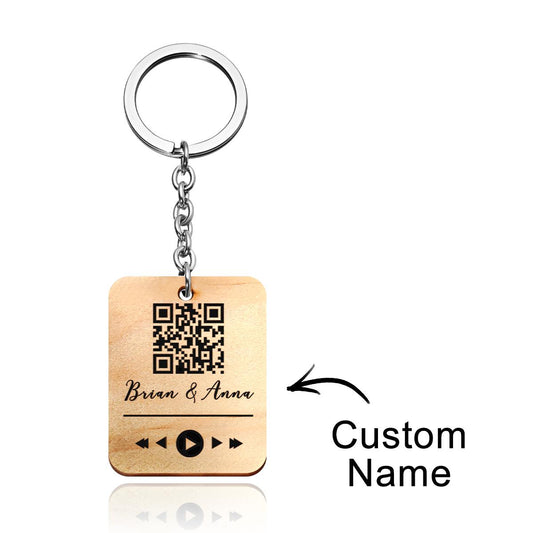 Detail view of the personalised wooden QR code keyring showing laser engraving and smooth finish — care: wipe dry to preserve wood