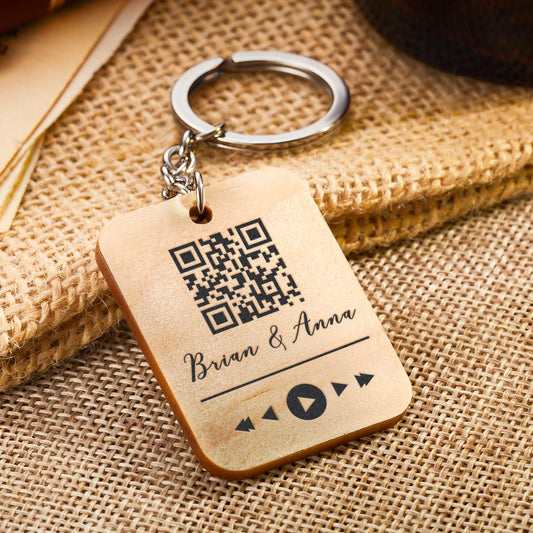 Detail view of the personalised wooden QR code keyring showing laser engraving and smooth finish — care: wipe dry to preserve wood