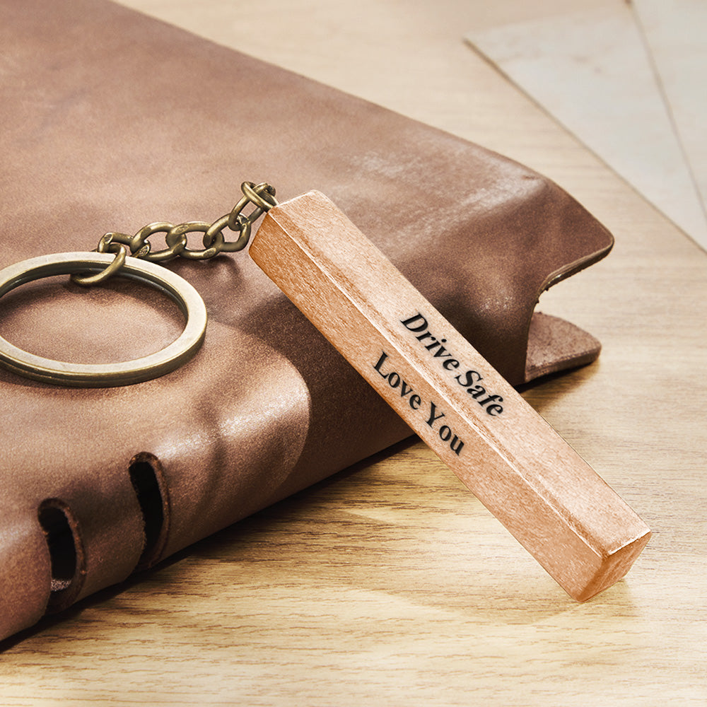 Close-up of four-sided engraved wood bar keyring variant A showing precision personalised engraving and clear text on natural wood