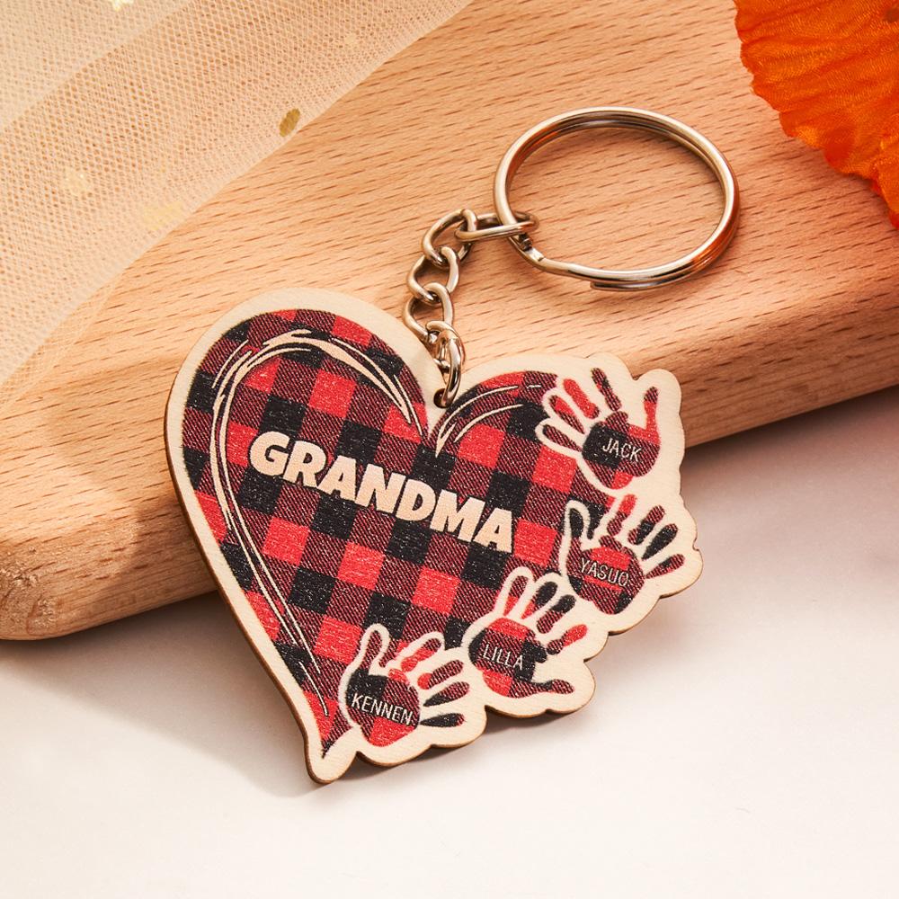 Custom engraved wooden hands keyring displayed with sample name and short message — ideal personalised gift for children or parents