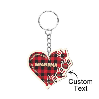 Close-up of personalised wooden hands keychain showing precise laser engraving and natural wood grain detail