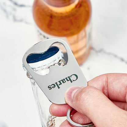 Close-up of personalised engraving on metal calendar keyring bottle opener showing custom name, date and fine engraving detail