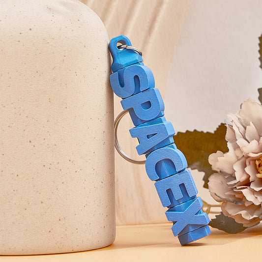 Personalised name keychain attached to a bag zip – colourful 3D printed custom tag for quick luggage identification