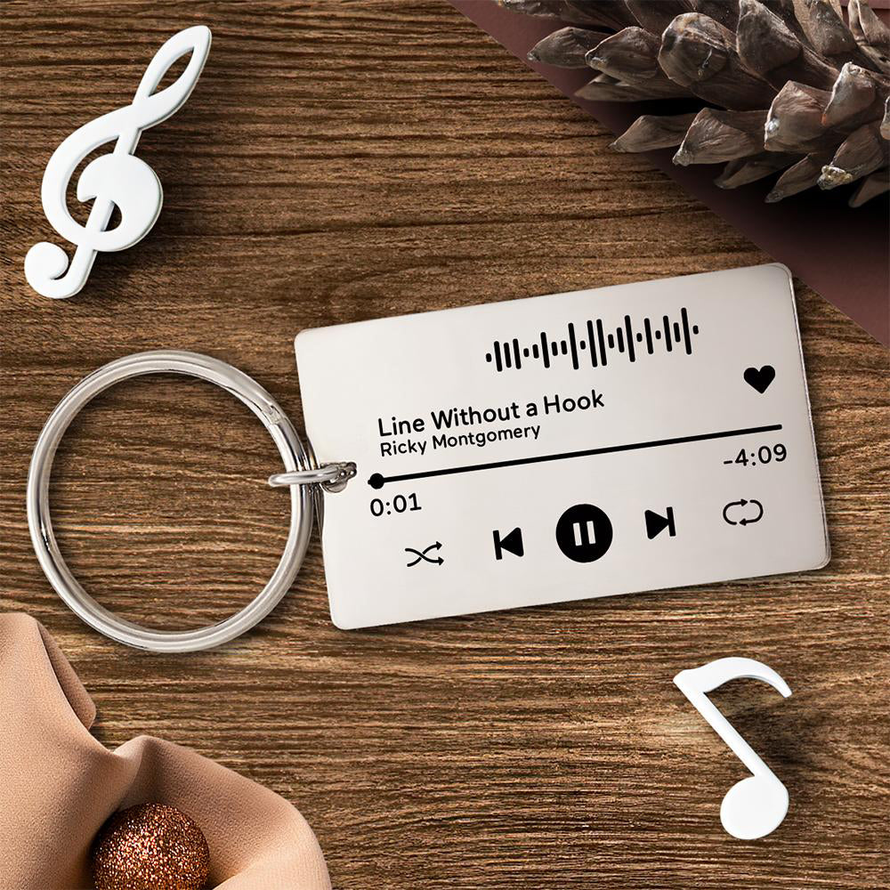 Close-up of engraved music code on clear acrylic plaque showing personalised text and scannable code — ideal customised song keepsake