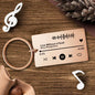 Black music code keyring attached to keys demonstrating size and stainless-steel fittings — personalised, durable custom song gift for him or her