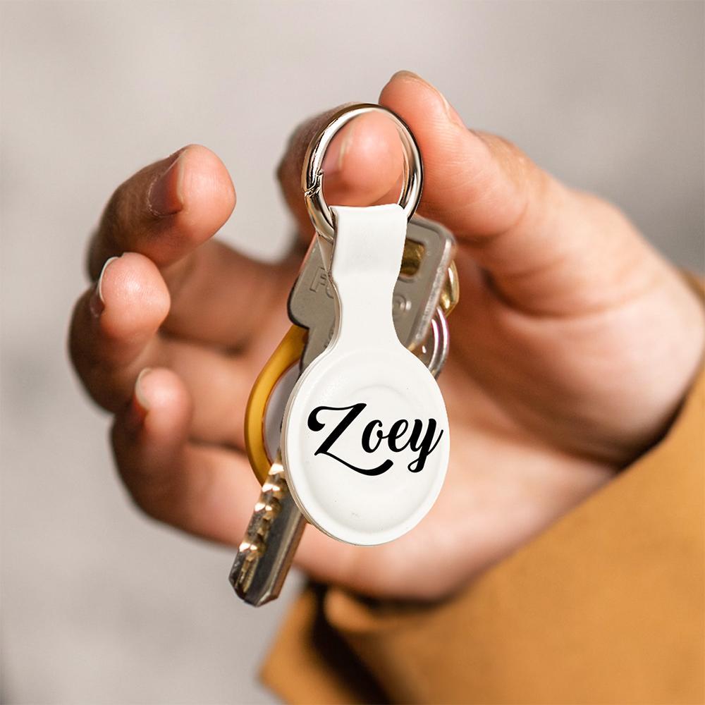 Silicone AirTag case attached to a set of car keys via metal keyring — custom AirTag keychain for keys, bags and luggage