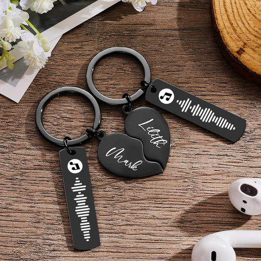 Pair of personalised heart-shaped stainless steel music code keyrings engraved with names and scannable music code — perfect Valentine's Day gift for couples