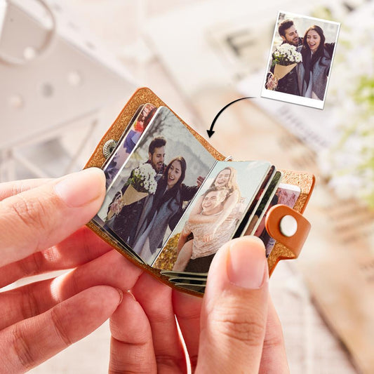 Fanned photographic prints removed from personalised leather photo keychain — high-quality photographic paper arranged as a charming surprise reveal