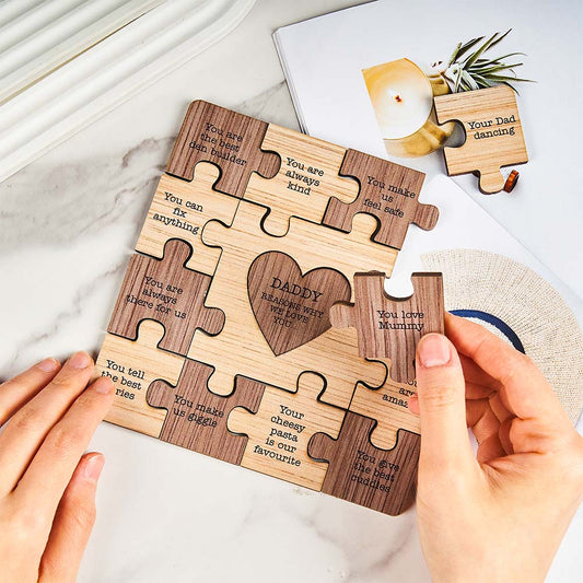 Engraved interlocking puzzle ornament hanging with ribbon on a Christmas tree, personalised timber gift for Dad or family keepsake