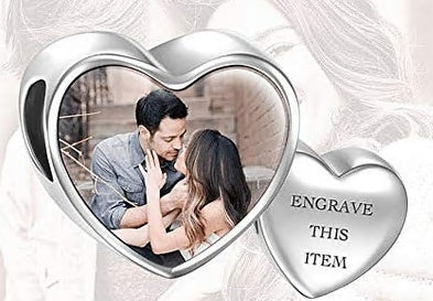 Close-up of personalised engraved heart photo charm with copper base and silver-plated oil-drip finish, double-sided clear photo — keepsake for bracelet or necklace