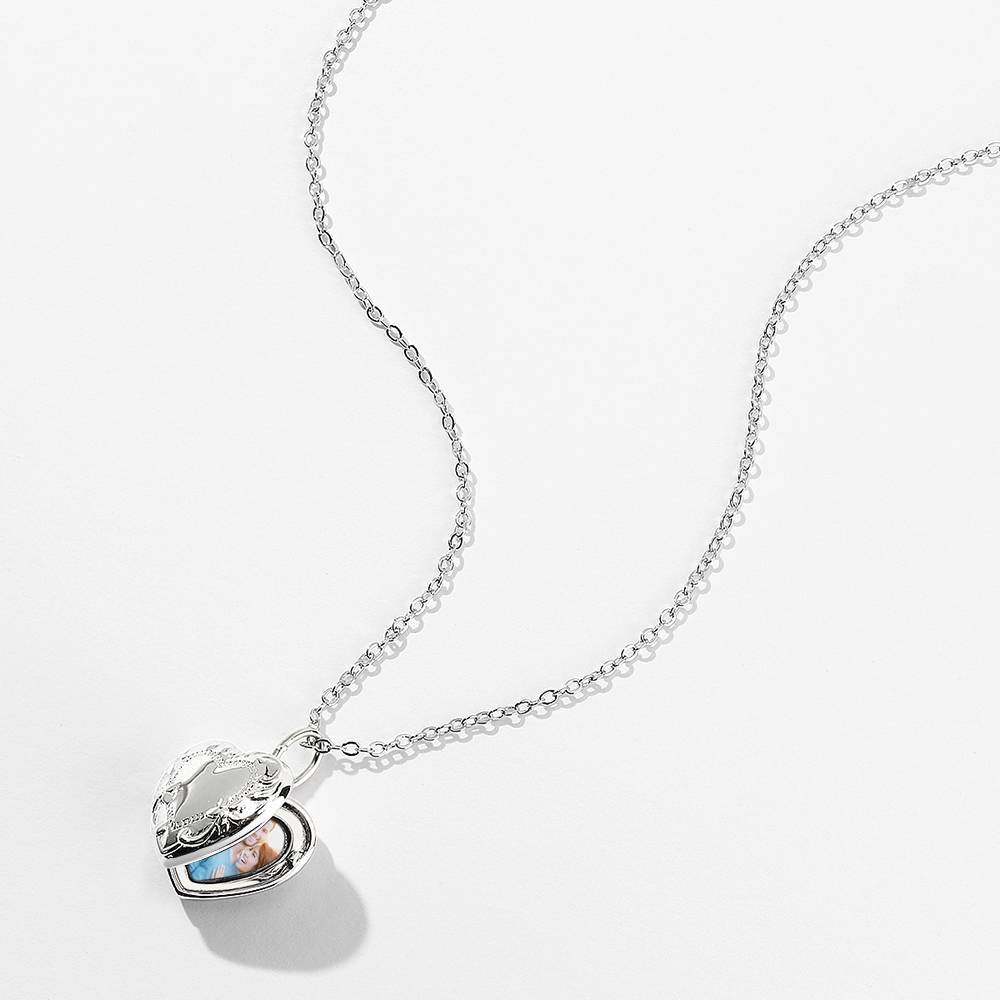 Close-up of embossed heart and fine engraved detail on platinum-plated photo locket for a personalised keepsake