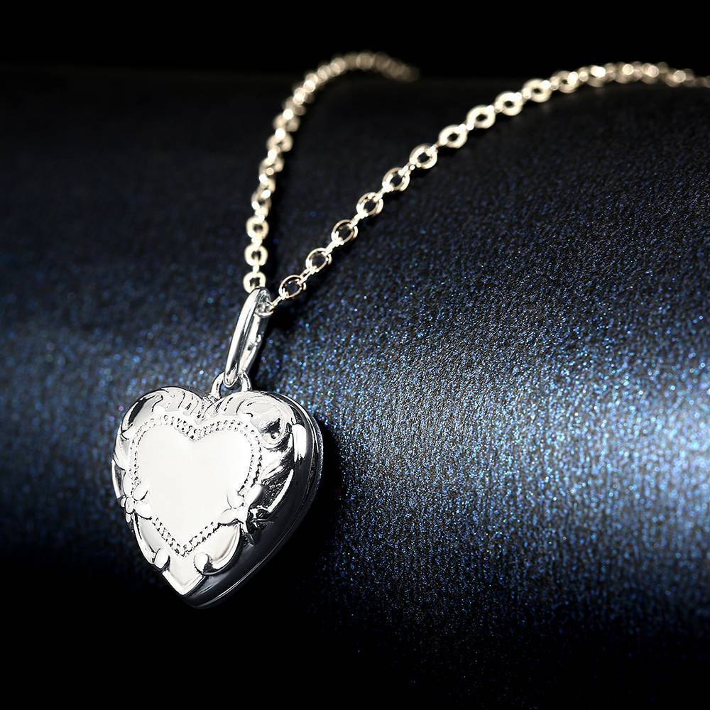 Back and hinge detail of platinum-plated photo locket showing space for engraved text and secure clasp