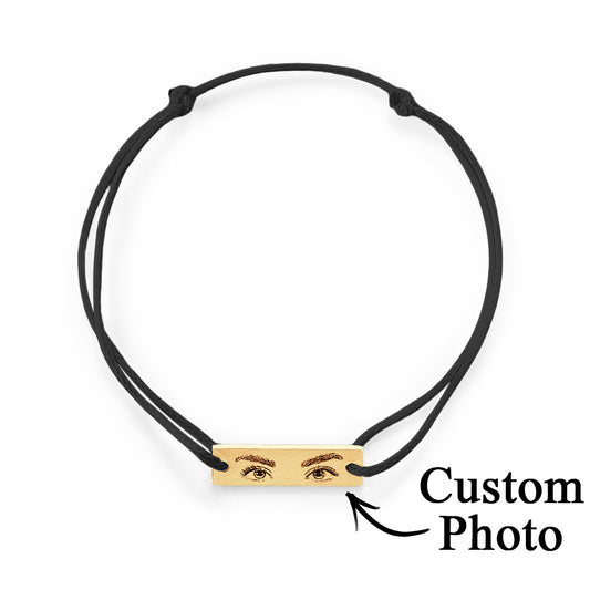 Personalised Eyes Photo Bracelet close-up of custom engraved eye on surgical-grade stainless steel charm with adjustable silk cord