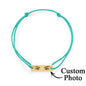 Lifestyle image of bracelet layered with other jewellery — personalised engraved stainless steel charm for everyday wear