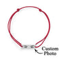 Hand model wearing personalised eyes photo bracelet — discreet stainless steel charm close to the skin