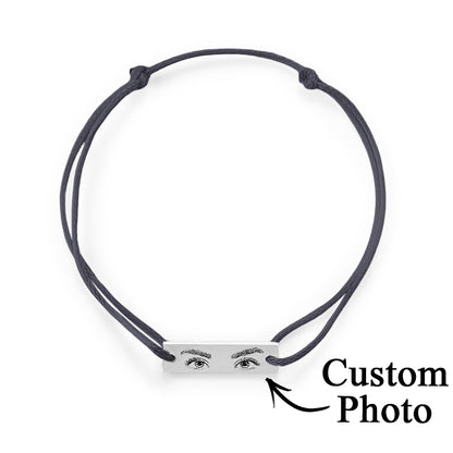 Detail image of the bracelet's hypoallergenic steel finish and the crisp engraving on the personalised eyes charm