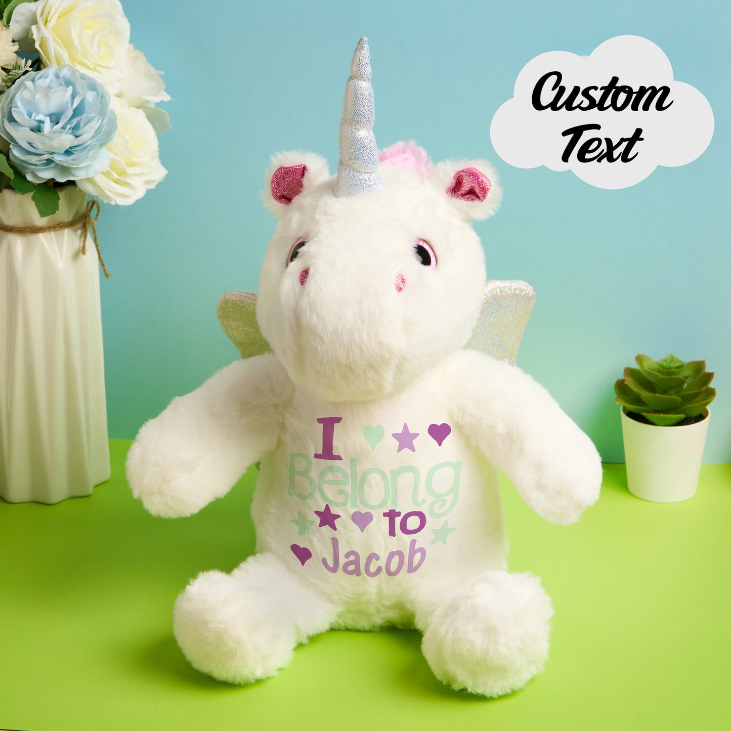 Close-up of embroidered baby name and birth stats on the unicorn plush, bespoke birth announcement teddy and newborn keepsake
