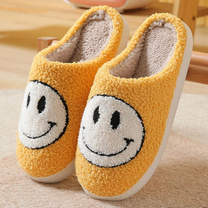 Lifestyle shot of unisex smiley face slippers worn at home — warm, fluffy house slippers perfect for living room and bedroom use