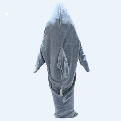 Person snuggled in flannel shark sleeping bag on bed — perfect novelty shark loungewear for sleepovers and camping