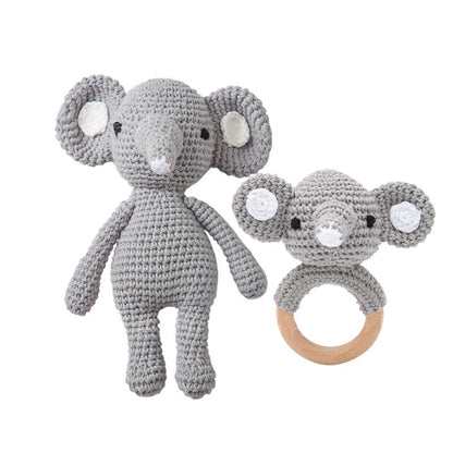 Textural macro showing crochet stitch detail and wooden ring join on a handmade baby rattle