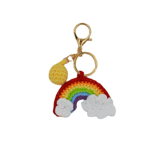 Rainbow handmade knitted keychain on plain background — cute crochet key pendant in woollen yarn with sturdy metal key ring, perfect as a bag decoration or keyring