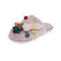 Model wearing Christmas Tree Angel plush slippers - easy on slip-ons with soft, skin-friendly plush and cosy padded support for winter mornings
