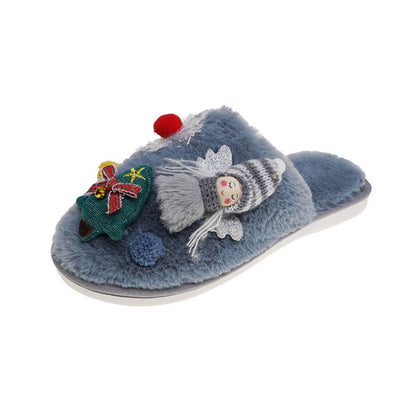 Close-up of embroidered angel and Christmas tree detail on plush slippers, highlighting soft fabric texture and seasonal decoration perfect for festive pyjamas