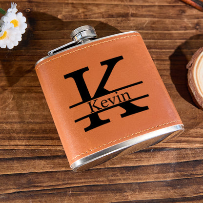 Compact 6oz personalised leather whisky flask held in hand to illustrate size (10.6 x 9.2 cm), stainless steel 304 core — ideal pocket flask and gifts for him