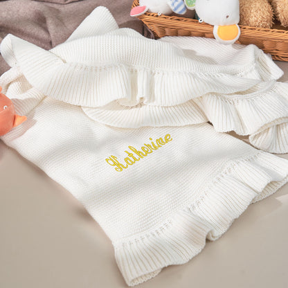 Close-up of embroidery and stitching on the baby blanket.