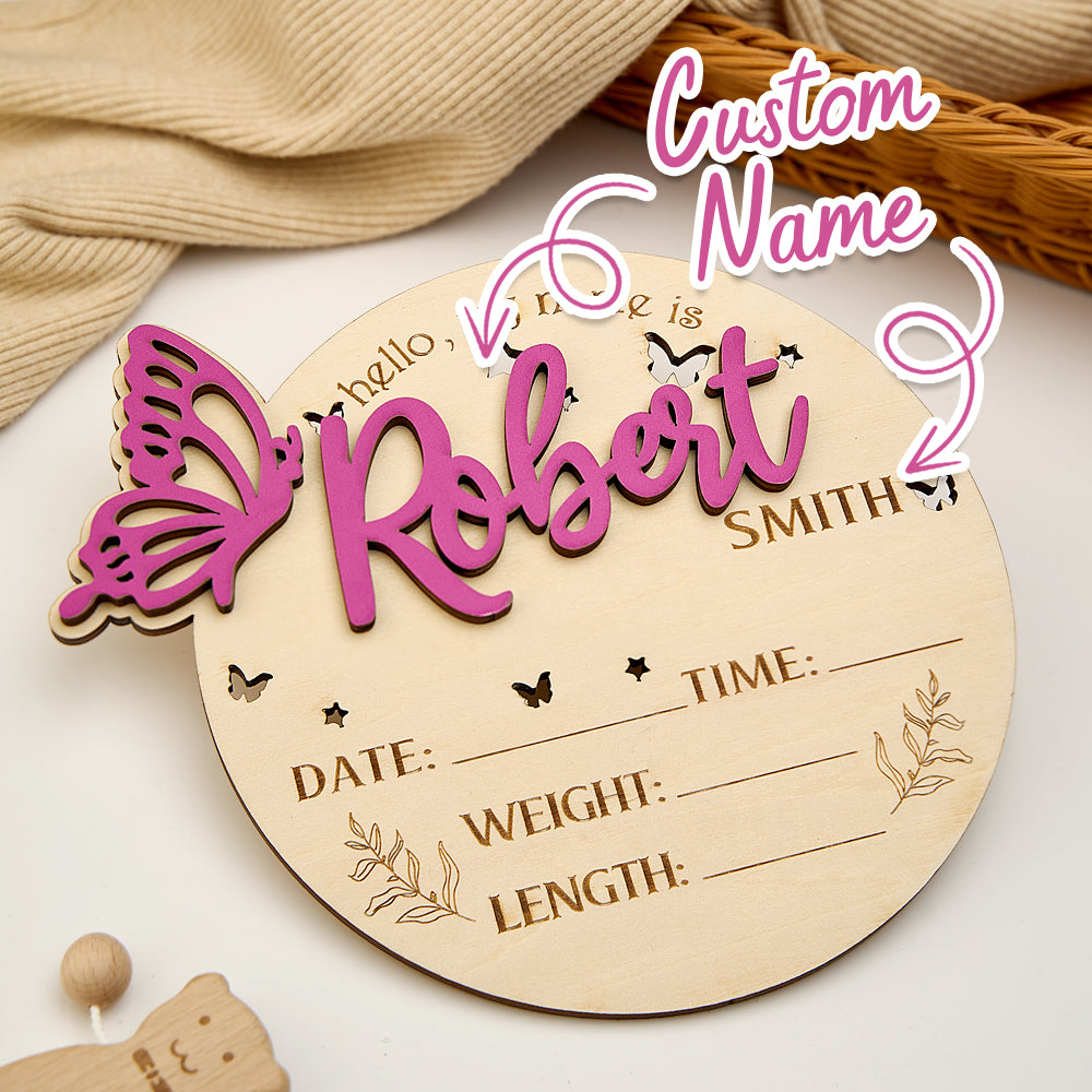 Two sizes of personalised butterfly birth announcement signs displayed side by side — 15.2cm x 13cm and 22cm x 19cm — wooden nursery keepsakes