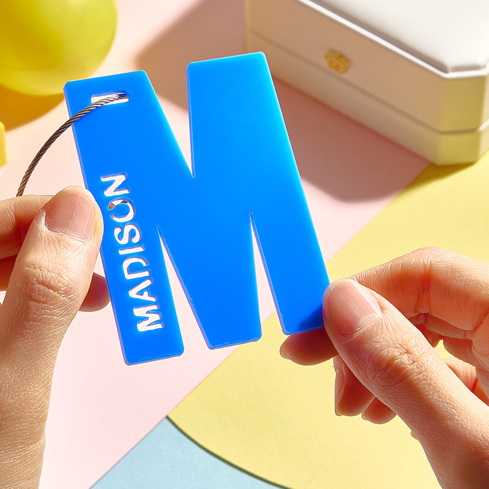Close-up of personalised acrylic name tag showing crisp custom text and vivid print quality for backpacks and luggage