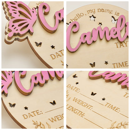 Scale comparison showing an adult hand holding the 22cm personalised butterfly birth announcement sign wooden photo prop for size reference