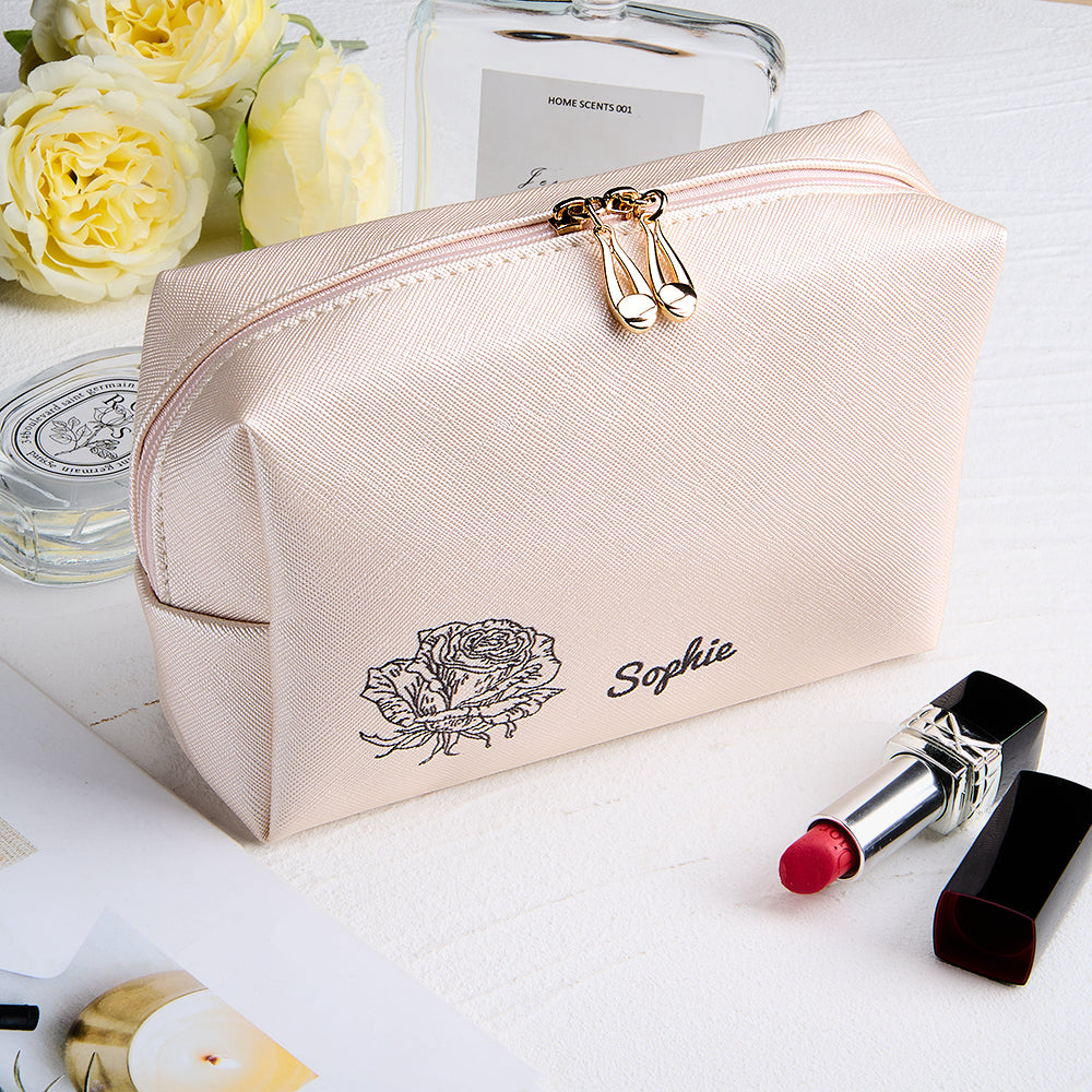 Angled view of personalised leather make-up bag highlighting embossed birth flower detail and secure zip closure — spacious cosmetic pouch for travel and daily use