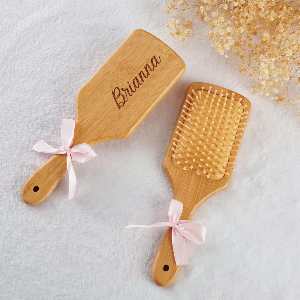 Row of personalised bamboo hairbrushes with different engraved names – ideal wedding favours and bridesmaid gifts made from sustainable bamboo