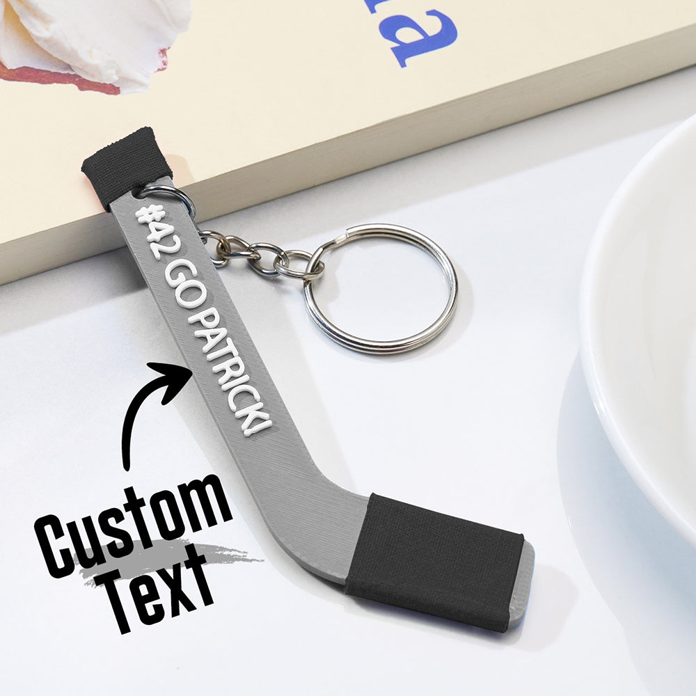 Scale reference image illustrating the tiny dimensions of the personalised 3D‑printed hockey stick keyring — ideal as a keepsake or key accessory