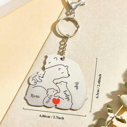 Hands holding personalised engraved Papa & Mama bear keyring to show scale and finish