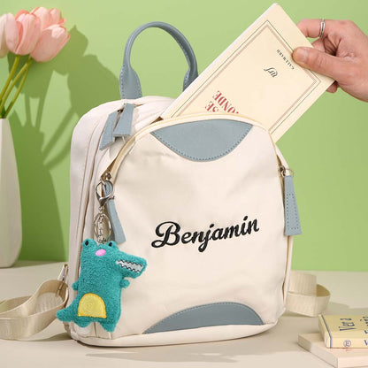 Close-up of personalised name embroidery and front pocket on mini backpack – durable Oxford fabric custom school bag for children